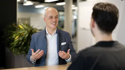 Thomas Donato in conversation with an employee.